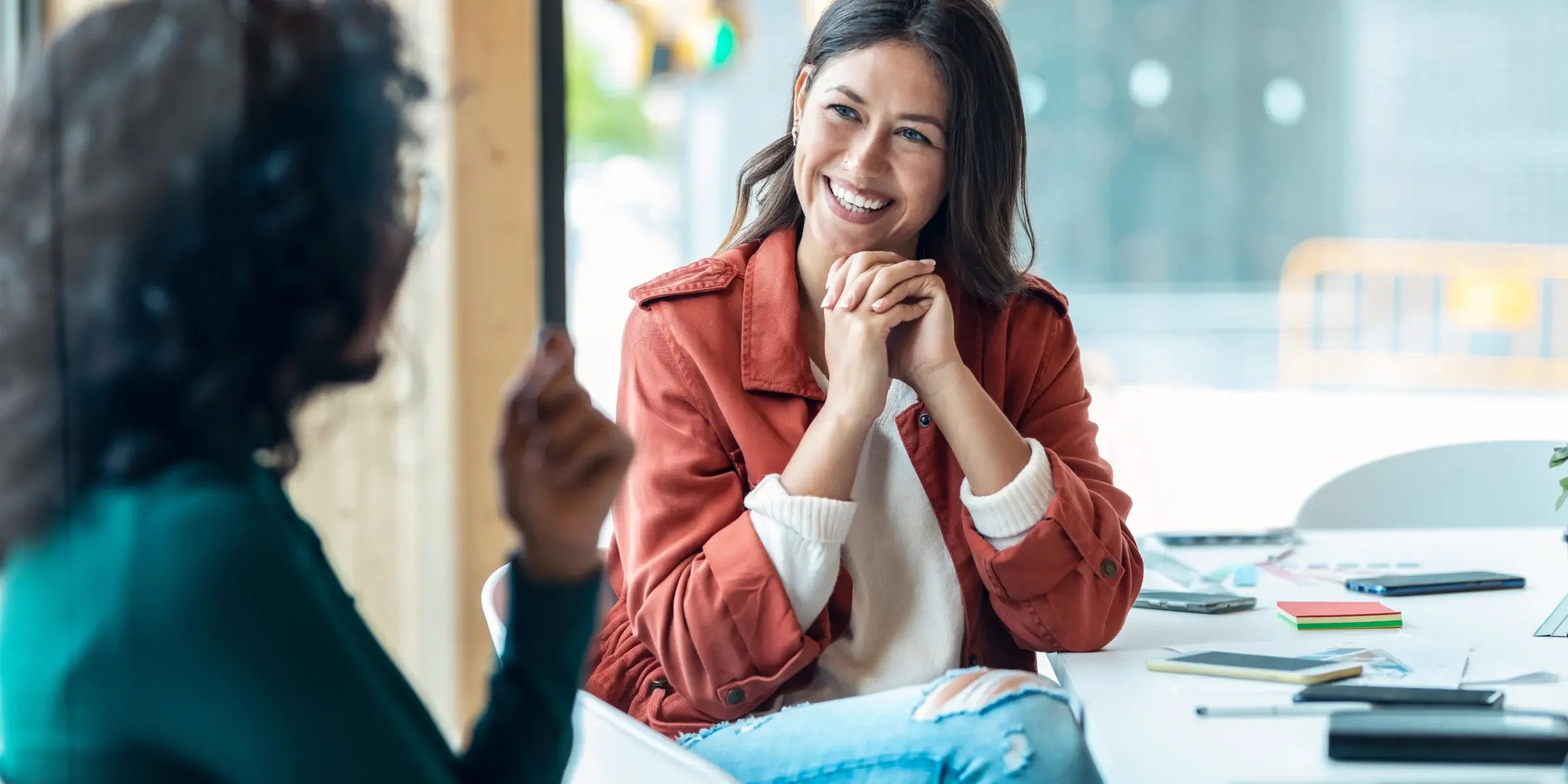 two people sitting and sharing advocate stories in a meeting